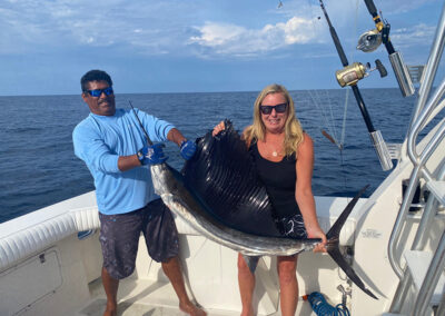 Rhonda and a fellow fisher holding a sailfish during a La Patrona Mazatlan excursion